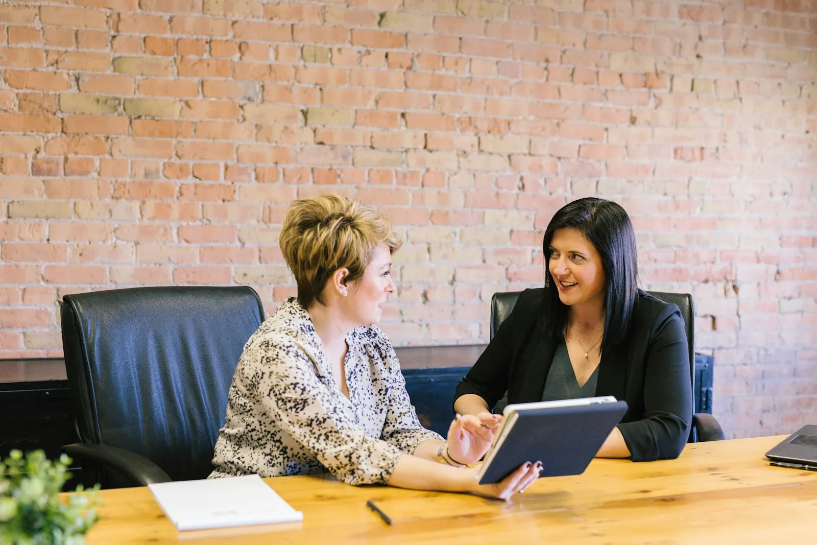 Two people reviewing work together at a desk